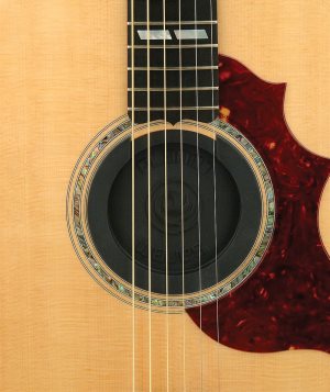 Acoustic guitar with a rubber soundhole cover